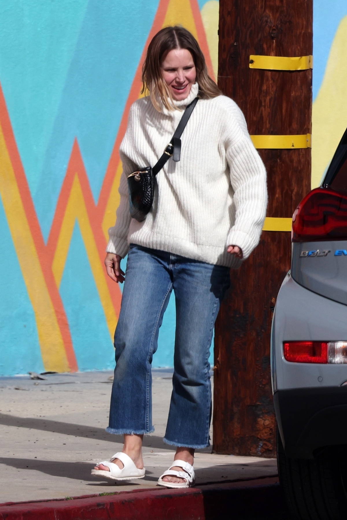 Kristen Bell wears a cream sweater and blue denim while out running errands  in Los Feliz