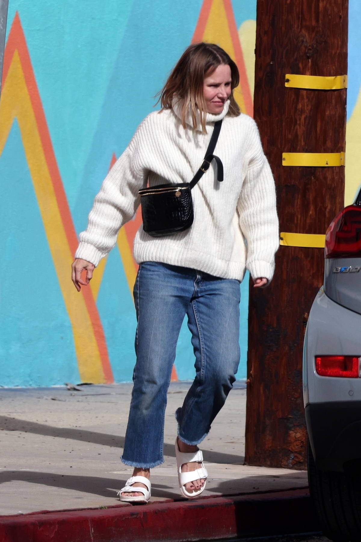 Kristen Bell wears a cream sweater and blue denim while out running errands  in Los Feliz
