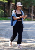 Lucy Hale stays comfy in a crop top and sweatpants with a blue sweater while out for a walk in Los Angeles