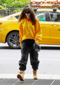Emily Ratajkowski dons a yellow sweatshirt and black joggers while heading into Sony Music Studios in New York City