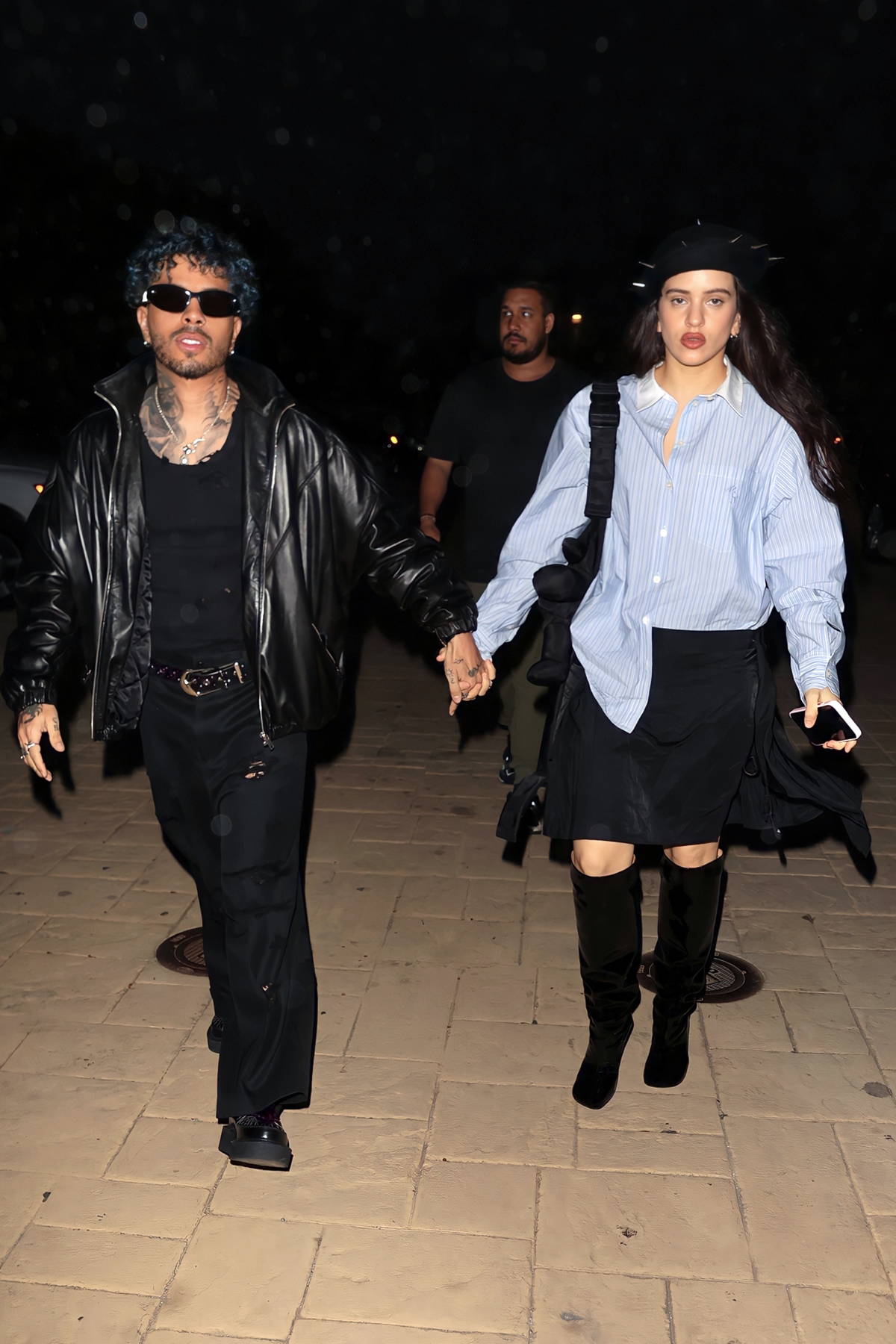 Rosalía and fiancé Rauw Alejandro step out holding hands during a