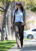 Olivia Wilde dons a light blue top and checkered trousers during a lunch outing with a friend in Los Angeles