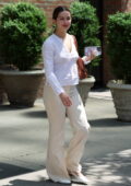 Addison Rae looks chic in a white top and cream trousers while heading out of The Bowery Hotel in New York City