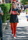 Addison Rae looks stylish in bright red tights to match her black and red t-shirt while out in New York City