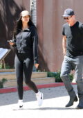 April Love Geary shows off her long legs in black leggings while