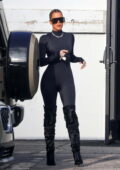 Khloe Kardashian displays her curves in a black bodysuit paired with thigh-high boots as she leaves a studio in Los Angeles
