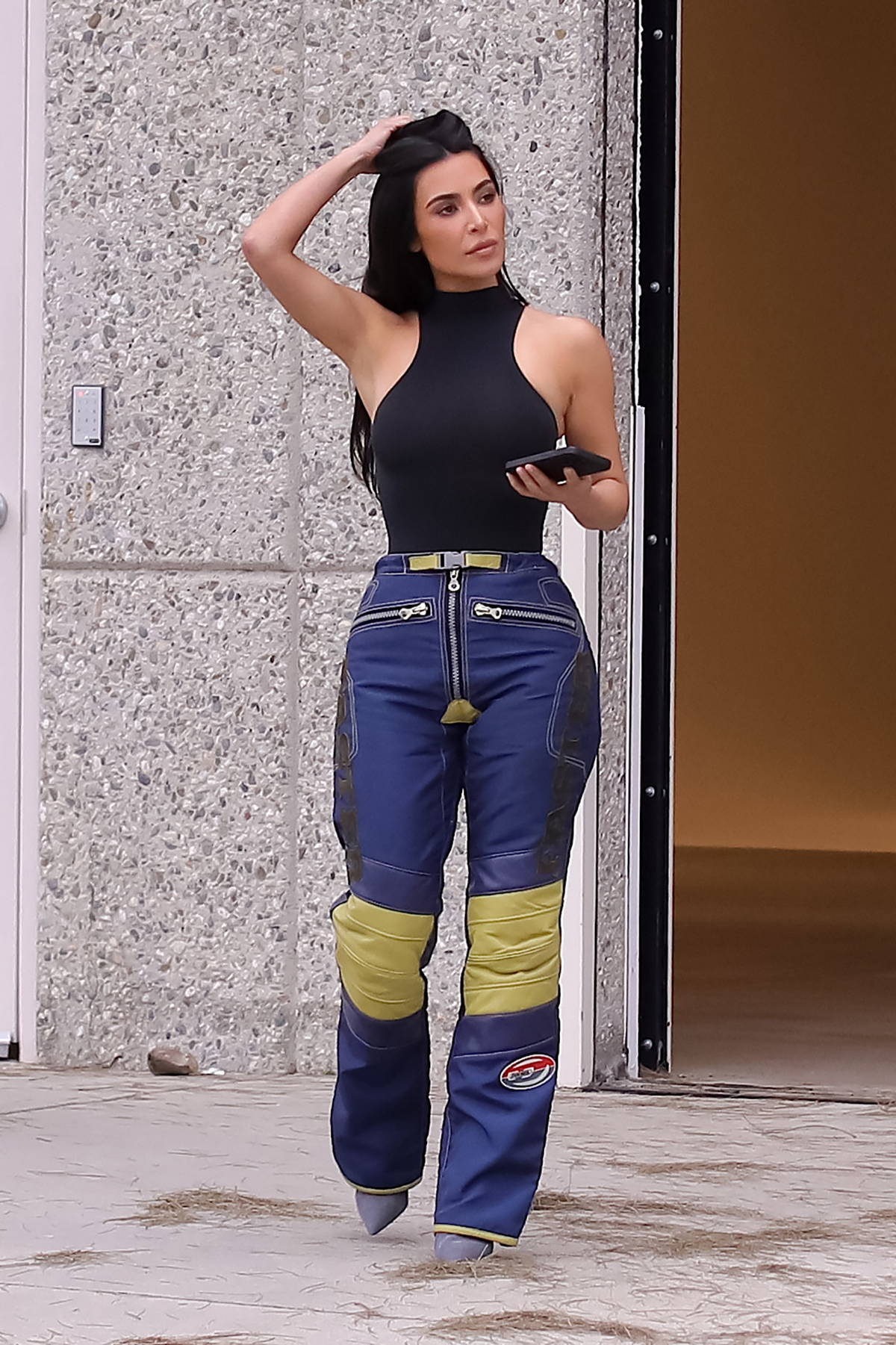 Kim Kardashian spotted in a black bodysuit with matching cargo pants while  taking a phone call