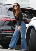 Minka Kelly is all smiles while stepping out wearing flared denim and a black top in Los Angeles