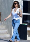 Minka Kelly looks stylish in a white vest and blue jeans while making a coffee run in Los Feliz, California