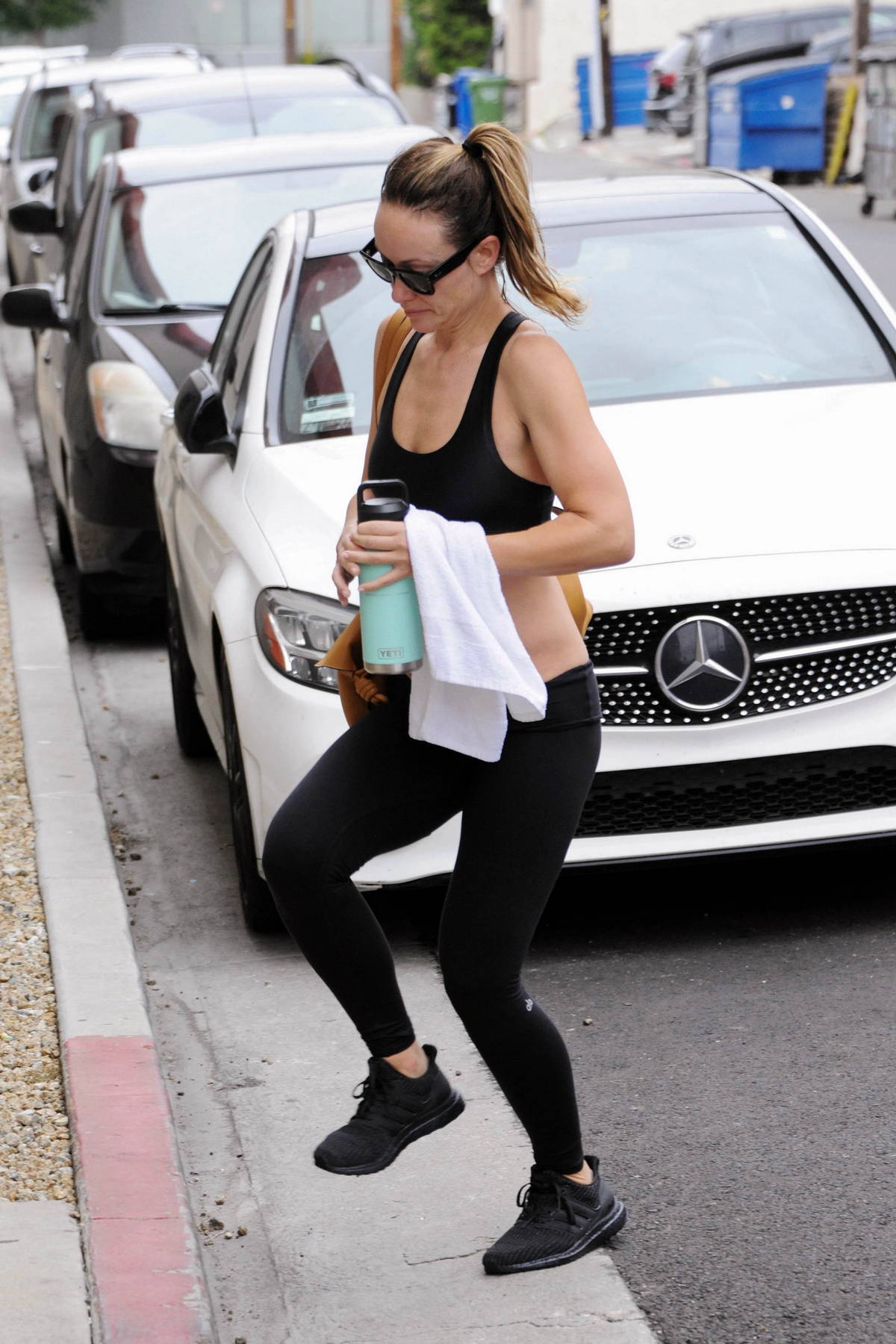 Olivia Wilde shows off her killer abs in a black tank top and