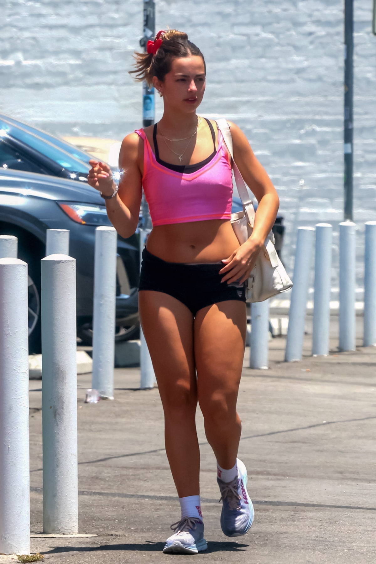 Addison Rae displays her toned abs in a black sports bra and tiny shorts  during a hike in Calabasas