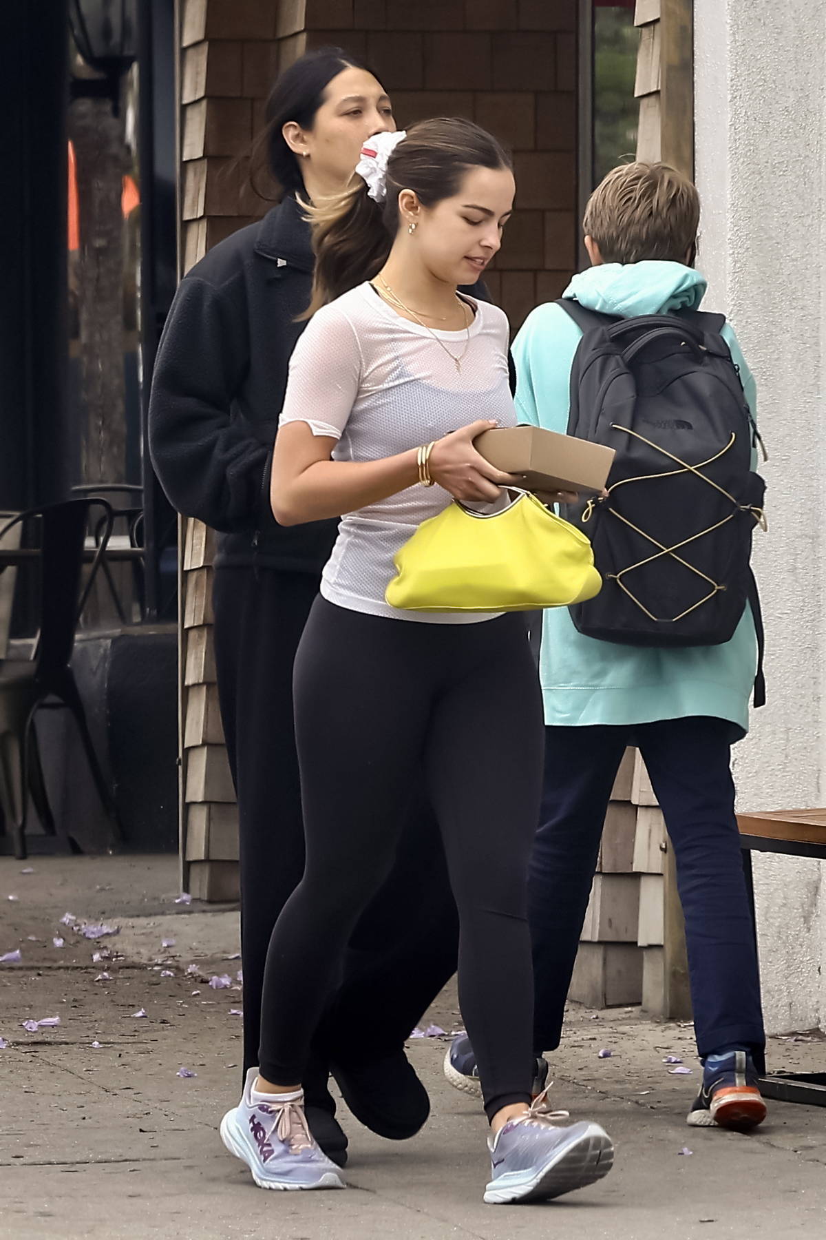 Addison Rae sports a semi-sheer white top and black leggings while she  grabs lunch with a friend at All Time Restaurant in Los Angeles-070623_11