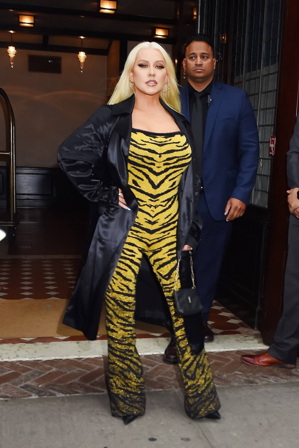 Christina Aguilera dons an animal print jumpsuit with a black trench coat  as she leaves The Greenwich Hotel in New York City-280623_1