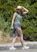 Elizabeth Olsen wears a camo top and navy shorts while out for a hike with a friend in Los Angeles