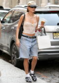Hailey Bieber keeps it casual in a camisole top and denim cut-offs while out shopping with Justine Skye in New York City