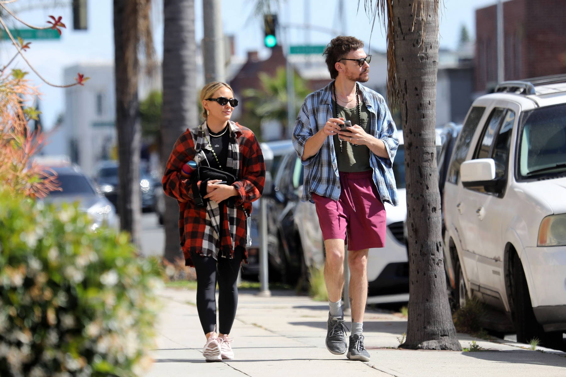 Hilary Duff wears a flannel shirt and leggings while stepping out