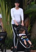 Karlie Kloss shows her baby bump while out for a stroll with her baby boy in Miami Beach, Florida