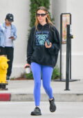 Mia Goth dons a black hoodie and blue leggings during a quick coffee run in Los Angeles