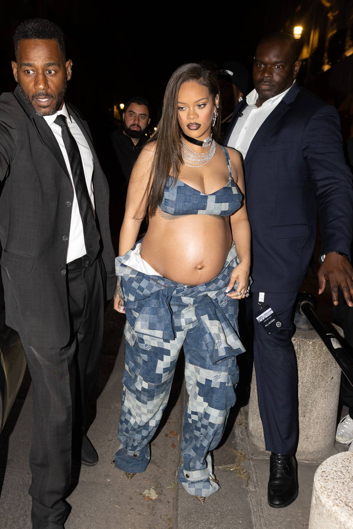 Rihanna bares her baby bump in a tiny bra top with matching pants while  heading out