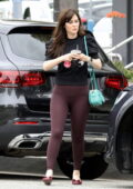 Zooey Deschanel looks fab in a black top and burgundy leggings during a coffee run at Caffe Luxxe in Brentwood, California