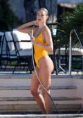 Kimberley Garner looks sensational in a yellow swimsuit while taking a shower at the Cheval Blanc Hotel in Saint-Tropez, France