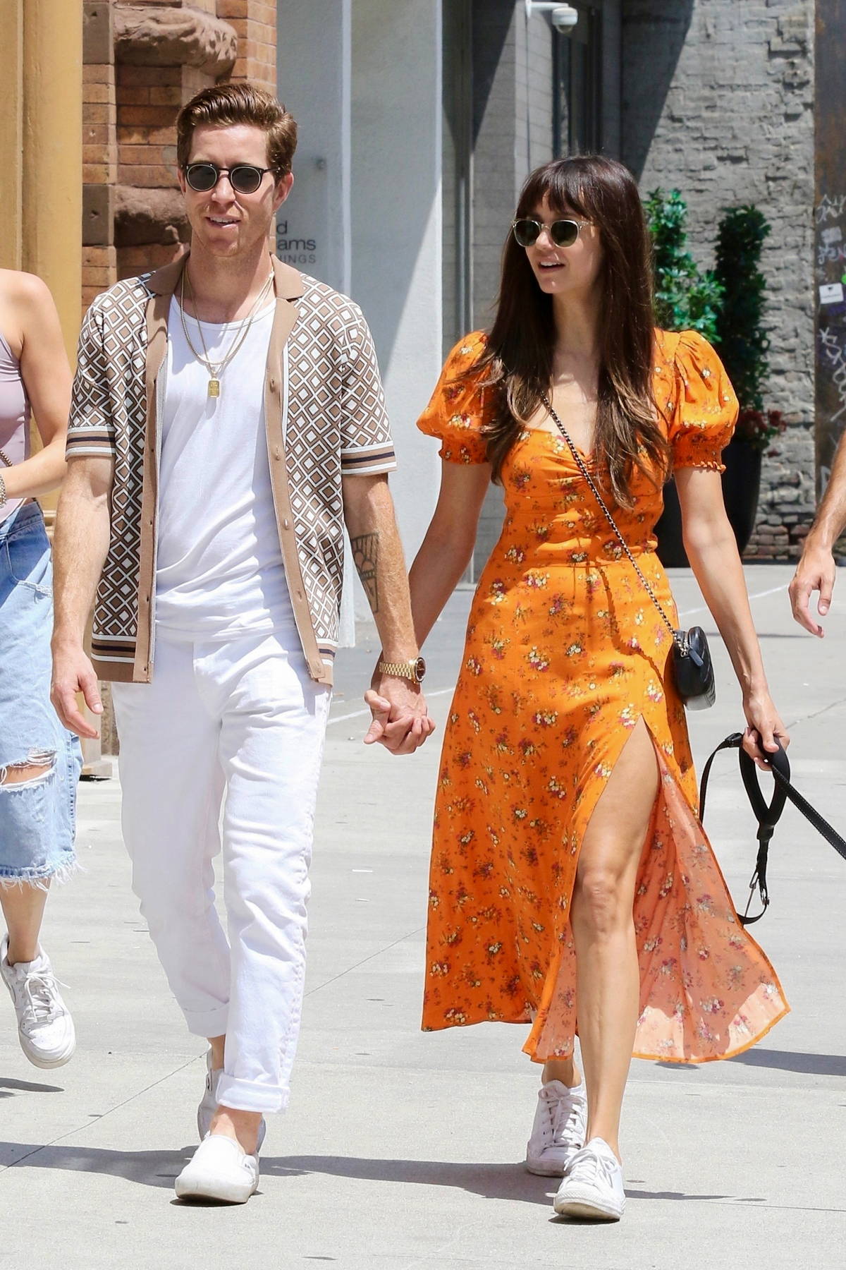 Nina Dobrev looks radiant in an orange summer dress while enjoying a stroll  with beau Shaun