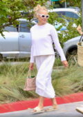 Pamela Anderson looks great in a white sweater paired with a white skirt as she goes shopping in Malibu, California