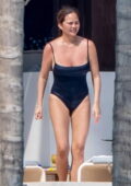 Chrissy Teigen slips into a black swimsuit while enjoying some downtime during her vacation in Puerto Vallarta, Mexico