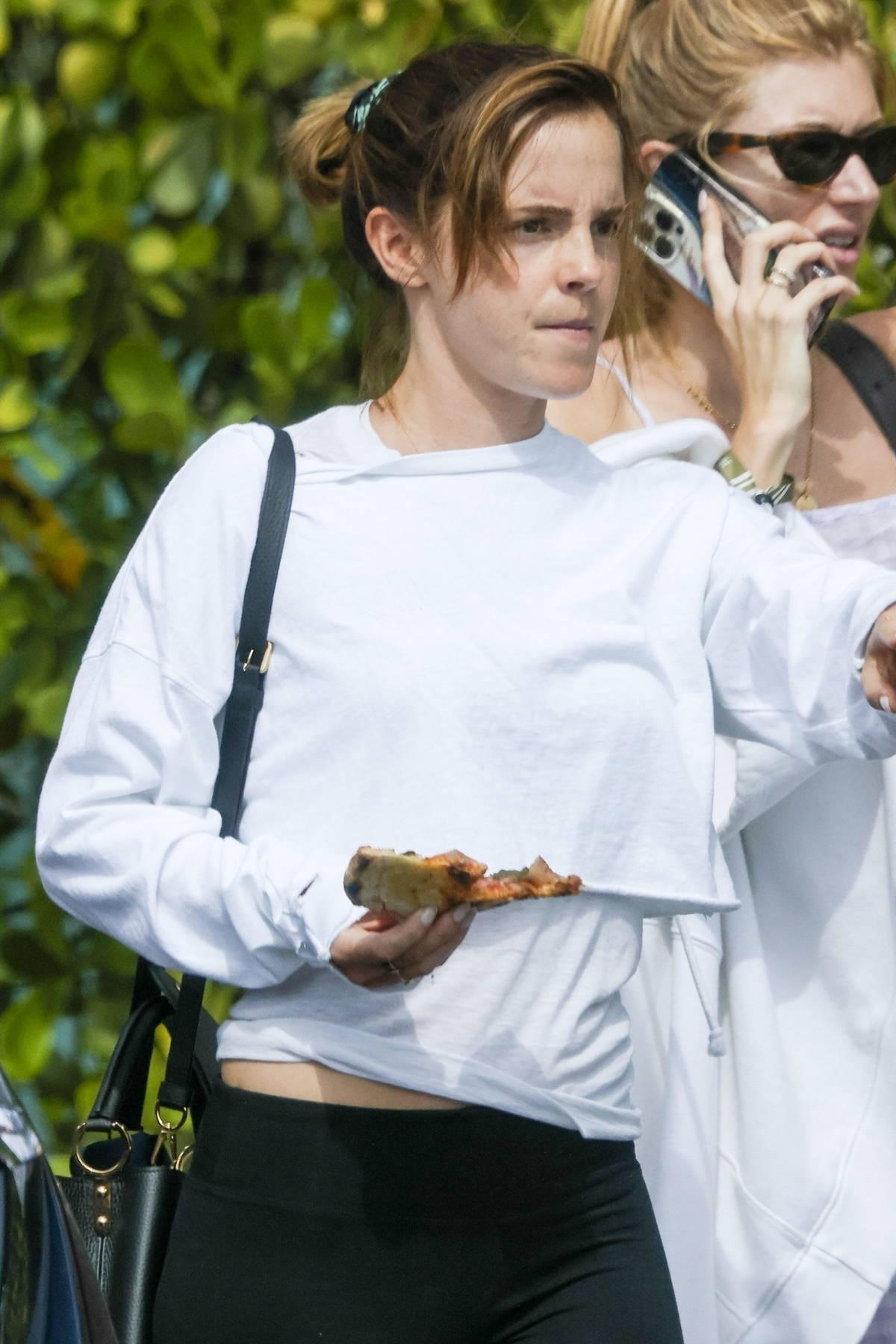 Emma Watson rocks a white sweatshirt and black leggings while stepping out  with friends in Miami