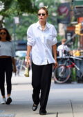 Gigi Hadid looks chic in a white shirt and black trousers during a solo outing in New York City