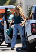Heidi Klum cuts a casual figure in a teal tank top and jeans while out running errands in West Hollywood, California