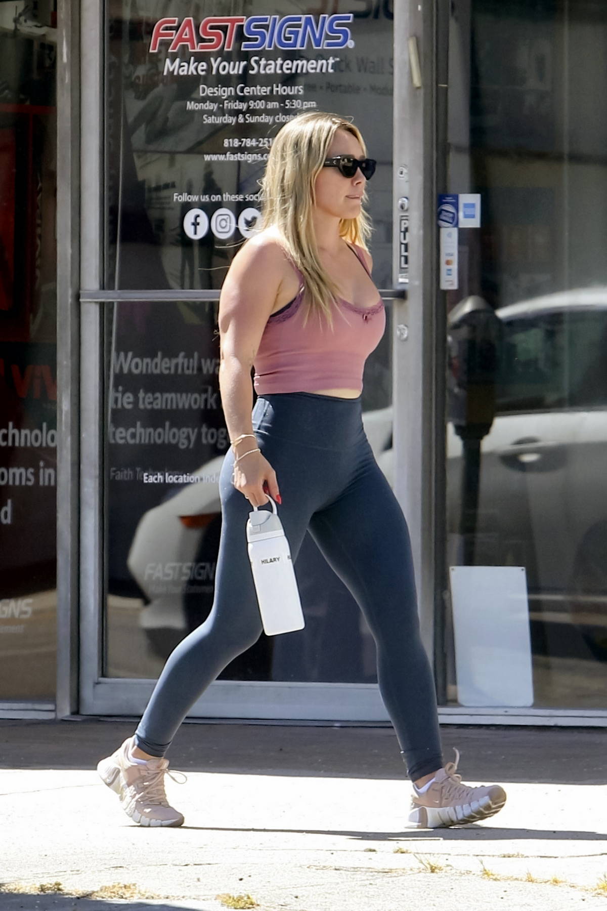 Hilary Duff flaunts her curves in a workout top and leggings during a  workout session at