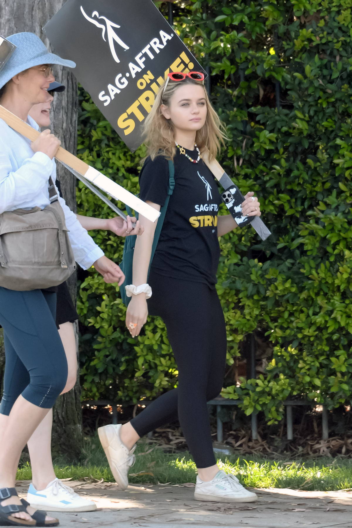 Francia Raisa shows off her curvy figure in a crop top and leggings while  walking her