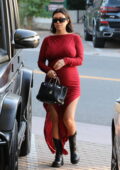 Kourtney Kardashian shows off her growing baby bump in figure-hugging red dress while out in Malibu, California