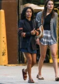 Yara Shahidi wears a black blazer and a denim mini skirt while out on a stroll with a friend in New York City