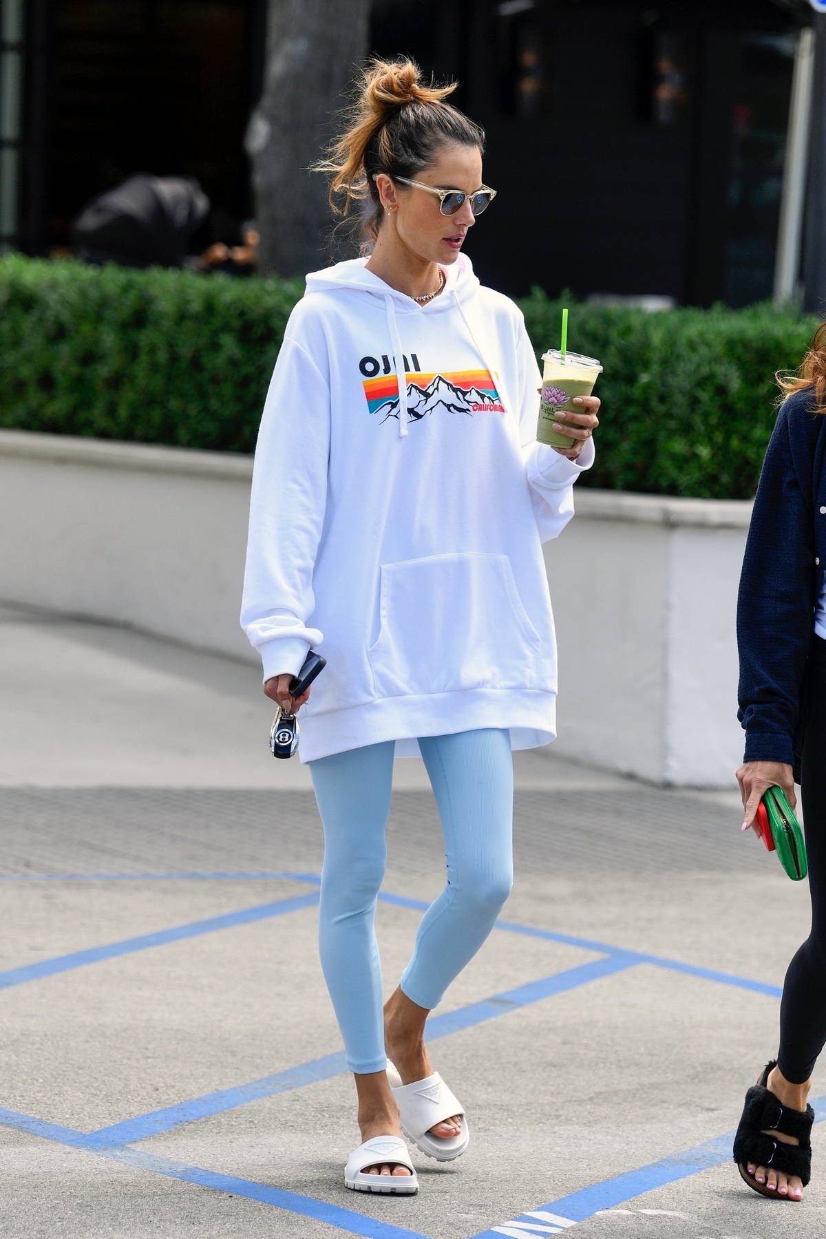 Alessandra Ambrosio looks radiant in an oversized white hoodie and