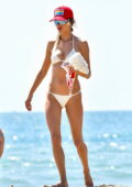 Alessandra Ambrosio shows off her stunning figure in a white bikini while enjoying the beach on Labor Day in Santa Monica, California