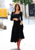 Emily Ratajkowski looks stunning in a black dress and red boots while stepping out during Paris Fashion Week in Paris, France