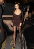 Hailey Bieber puts on a leggy display in a brown minidress while attending an afterparty at Voltaire in Paris, France