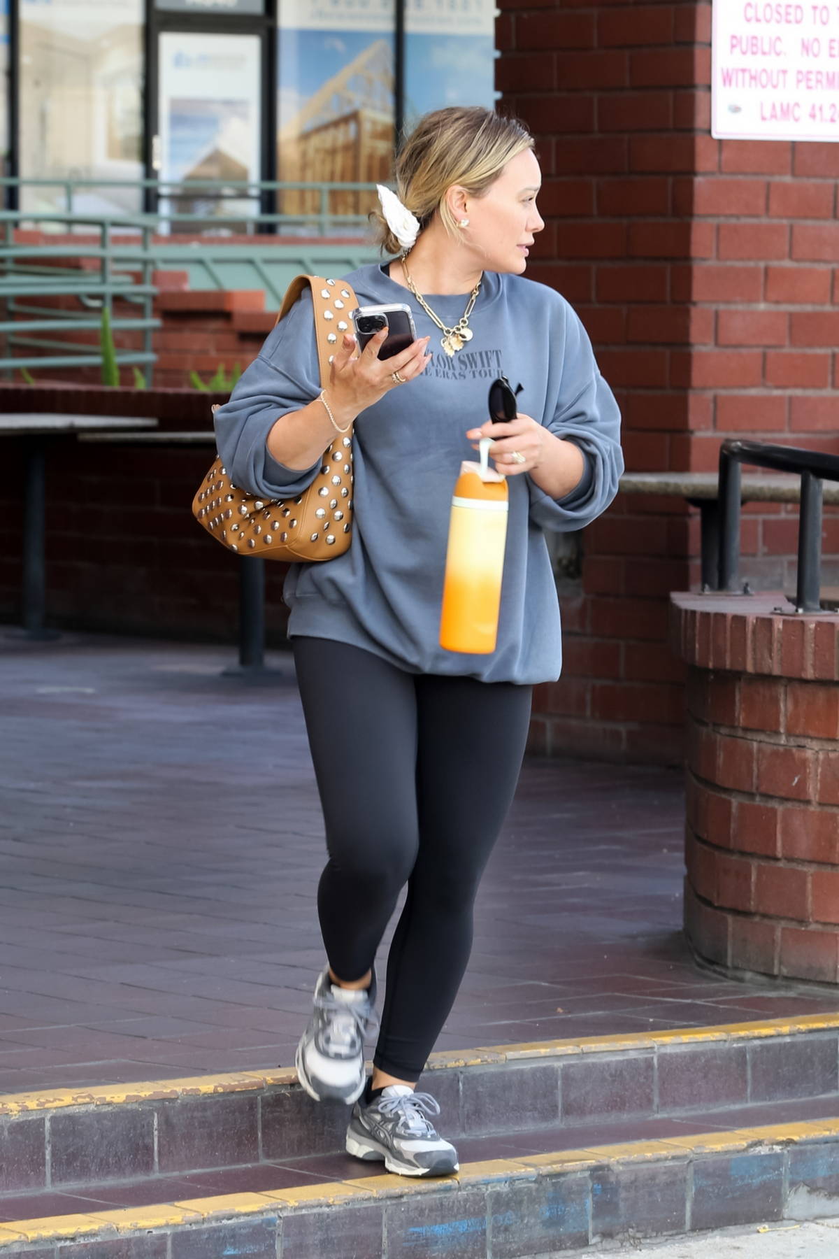 Hilary Duff sports a black top and leggings as she heads to the