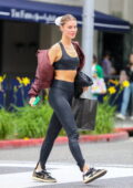 Joy Corrigan shows off her svelte figure in a black sports bra and