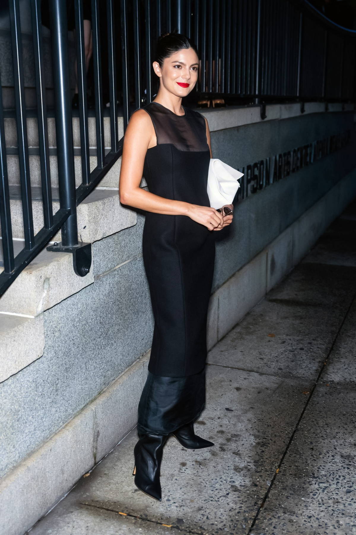 Shanina Shaik rocks black leather pants with a white tank top and boots  while stepping out