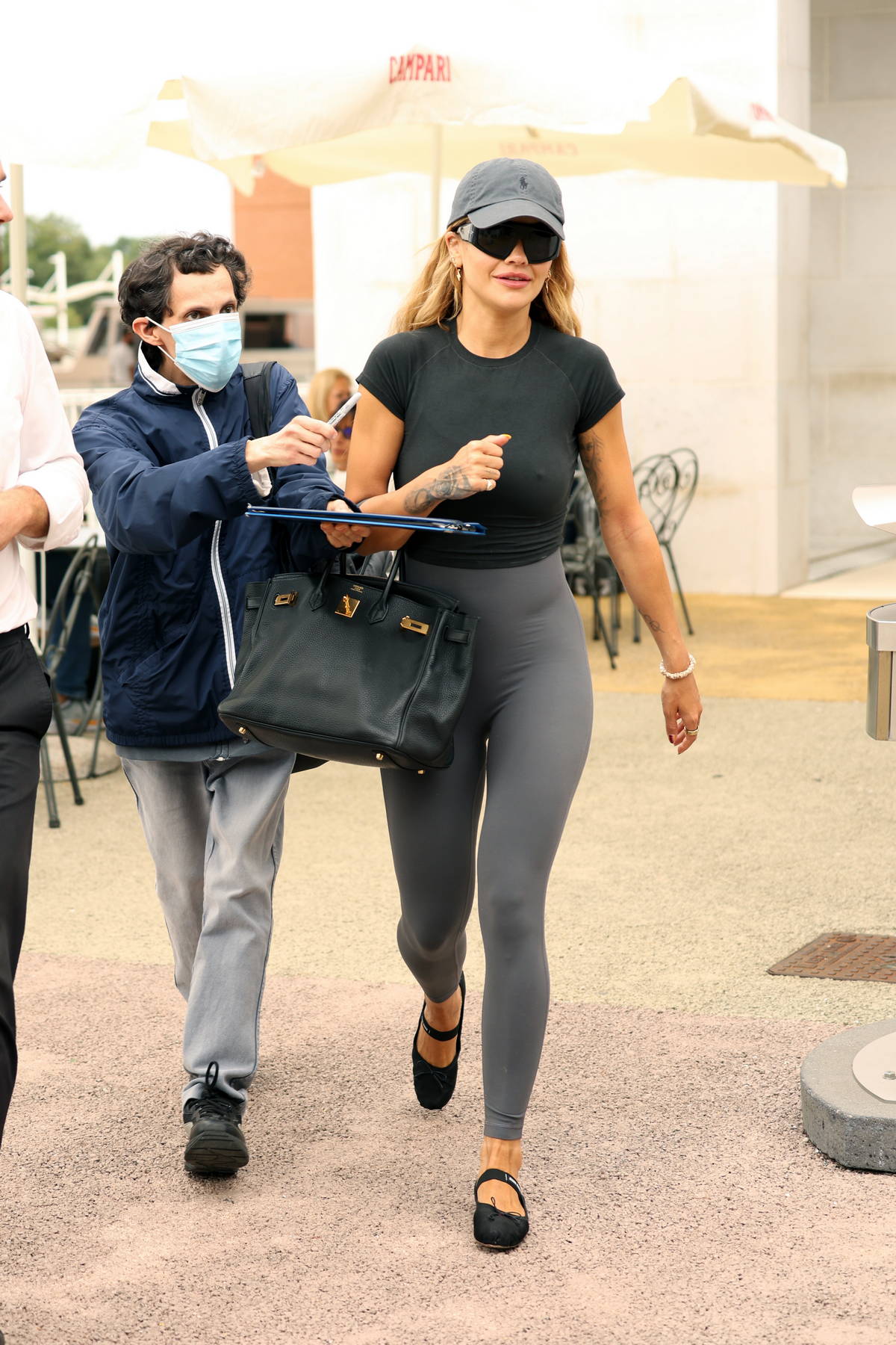 kendall jenner sports a cropped blue sweatshirt and black leggings