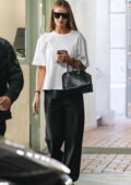 Rosie Huntington Whiteley opts for a white t-shirt and black trousers while stepping out with Jason Statham in Beverly Hills, California