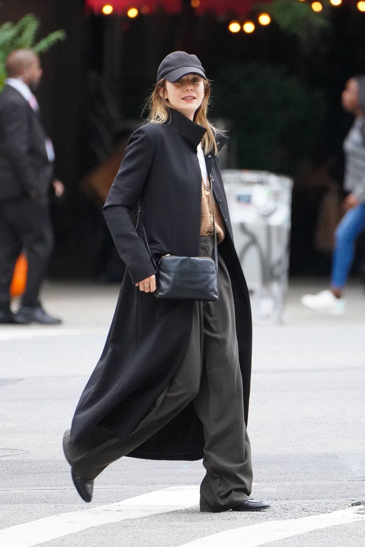Elizabeth Olsen wears a black trench coat with baggy trousers while out for a stroll with husband Robbie Arnett in New York City 191023 3