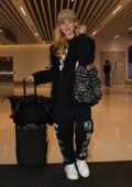 Kathryn Newton looks casual yet trendy in a black sweatsuit with matching blazer as she touches down at LAX in Los Angeles