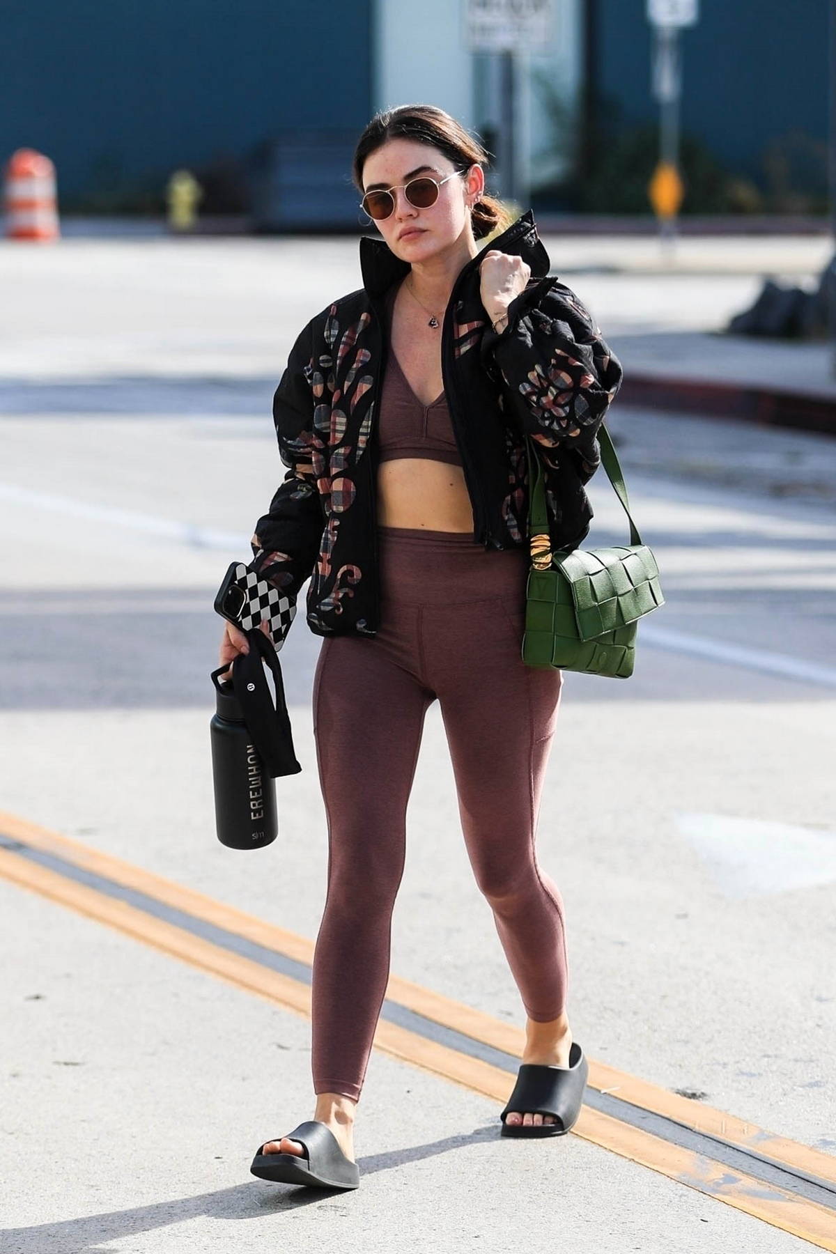Lucy Hale sports a brown sports bra and leggings for a hot yoga