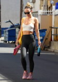 Olivia Wilde showcases her rock-hard abs in a white crop top and black  leggings while