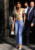 Zendaya looks stylish in a gold crop top and denim while stepping out during Paris Fashion Week in Paris, France