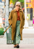 Blake Lively bundles up in an orange turtleneck with a mustard overcoat while stepping out in New York City